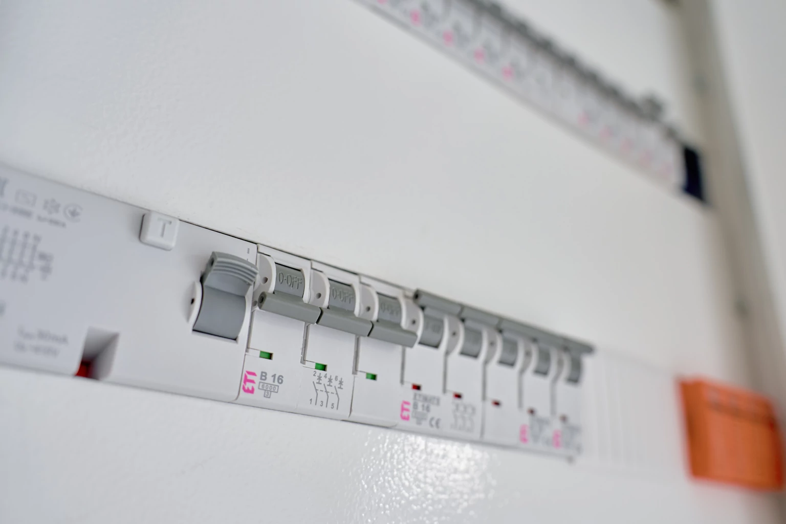 Power distribution board with row of circuit breakers and switches